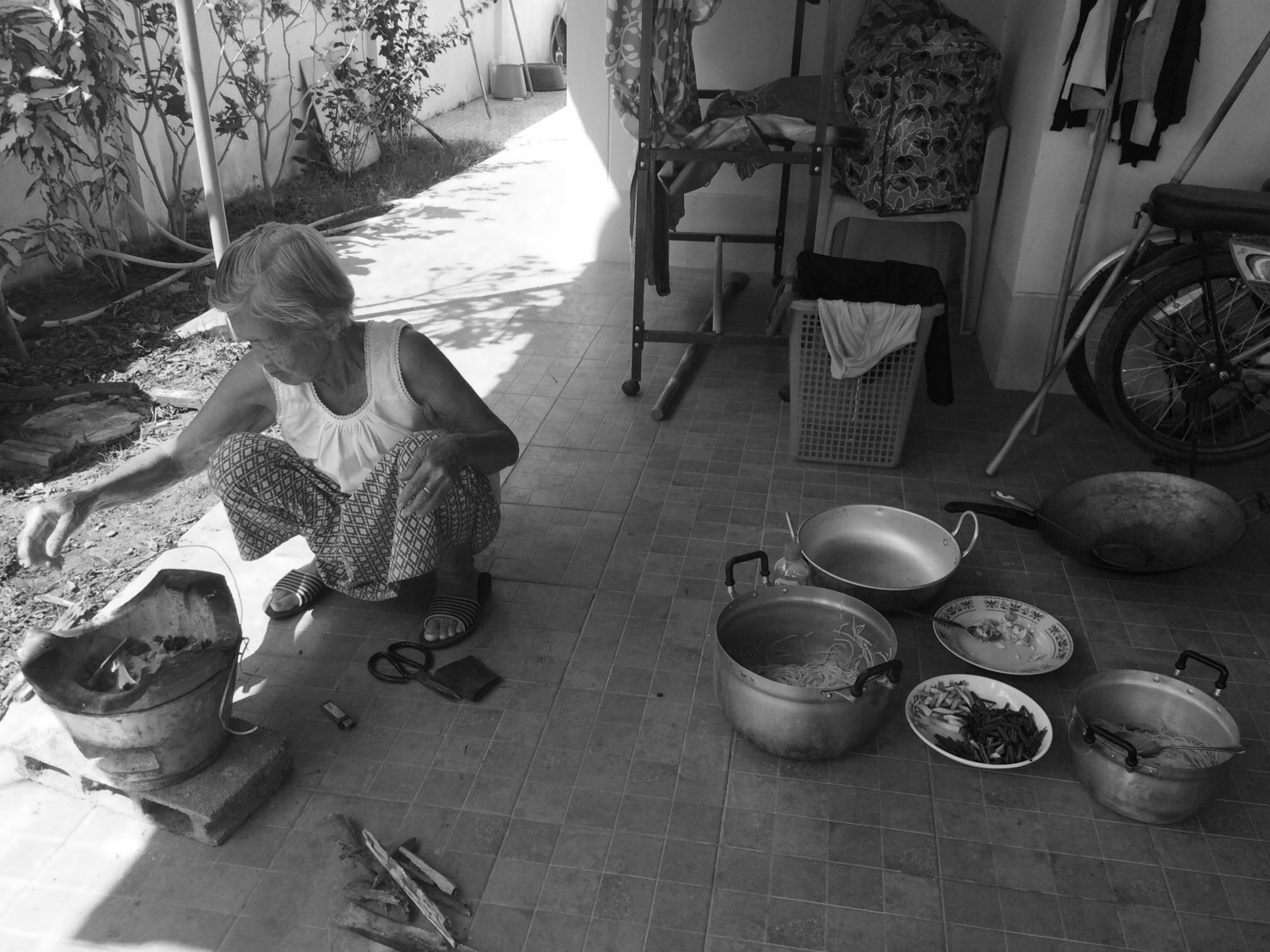 Ma Rew — Mother Rew cooking over charcoal